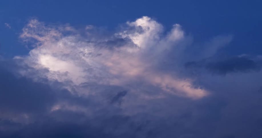 Clouds move across a blue sky