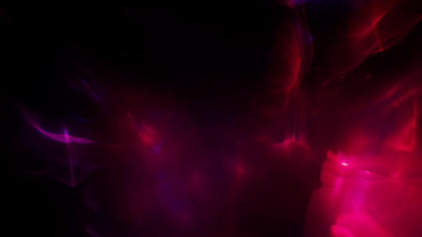 Colorful lights shine through haze that swirls and fades