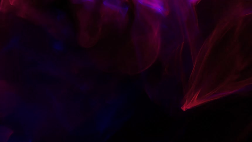 Pink shapes of light are moving around in the darkness