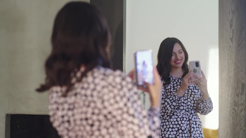 A woman taking a photo of herself in a mirror