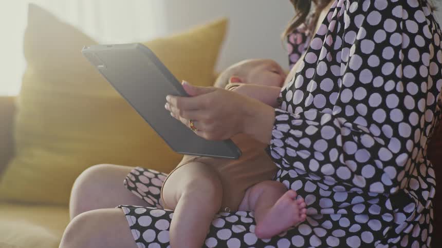 A mother is breastfeeding her baby