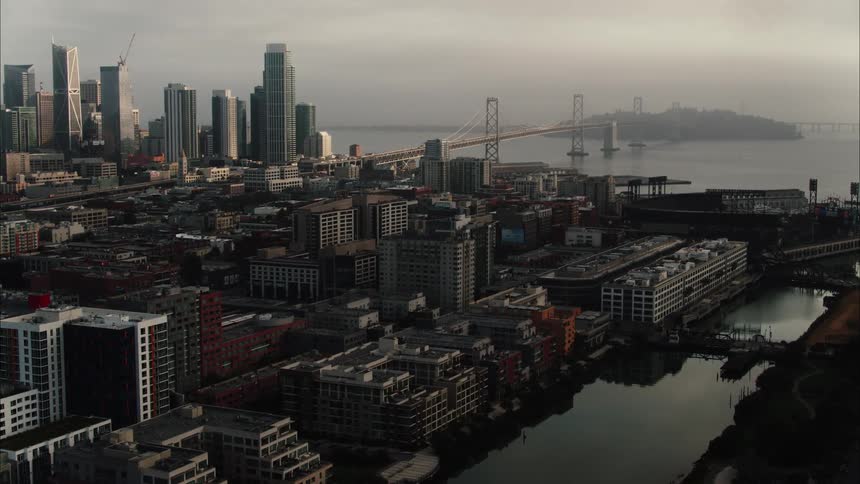 City with tall skyscrapers and a bridge stretching across the water