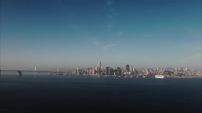 Skyscrapers and buildings in a city skyline near an ocean bay