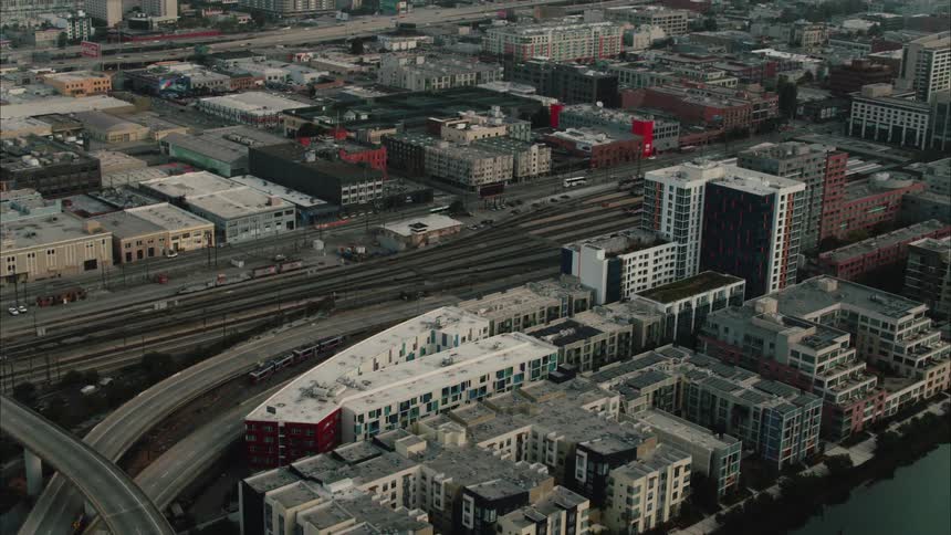 Highway over the train tracks in a coastal city neart a bridge over the ocean