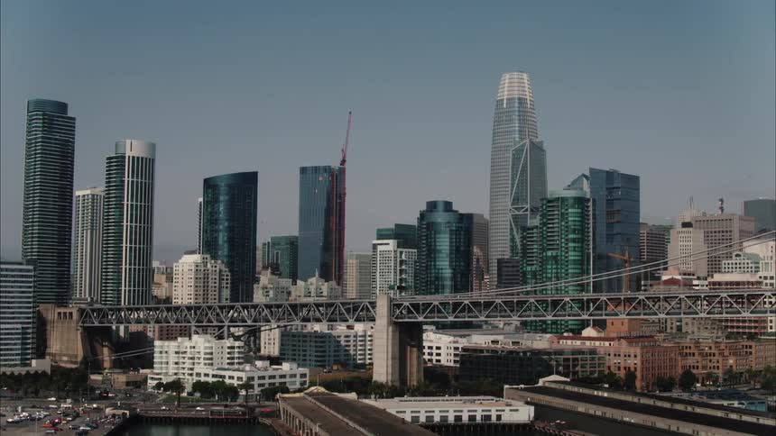 Heavy traffic passes through a downtown city along the coast