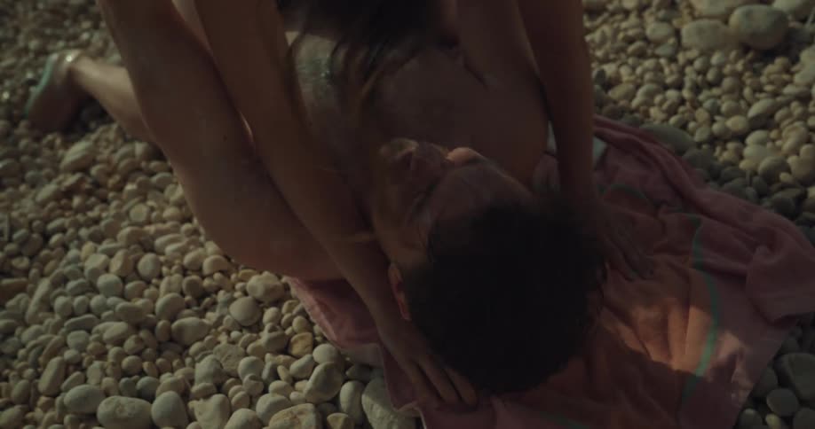 A couple play around on the beach together