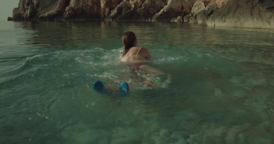 A boyfriend and girlfriend kissing outdoors in the ocean