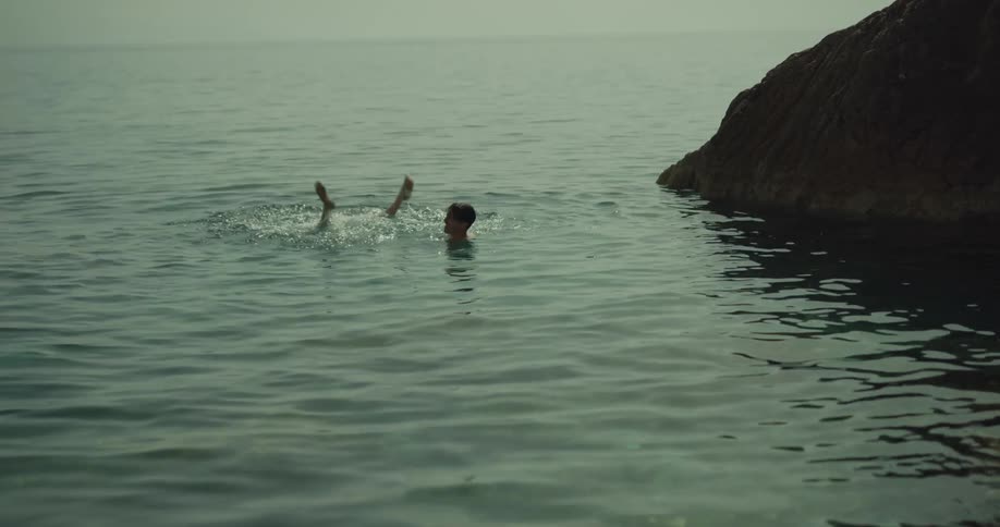 Two people swimming in the ocean