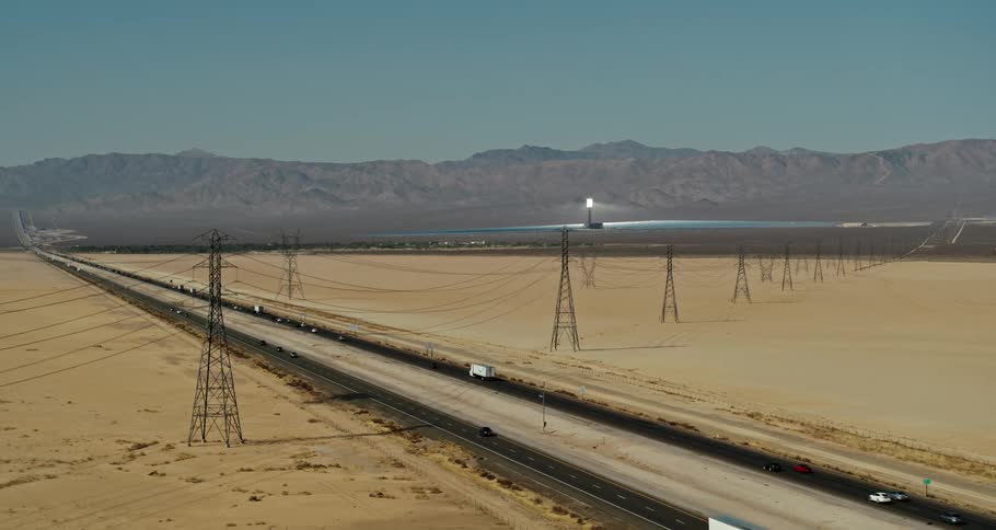 Vehicles travel on the highway through the desert