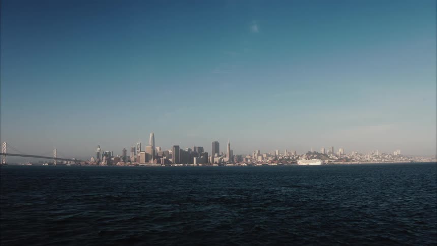 In the far distance past the water is a large city