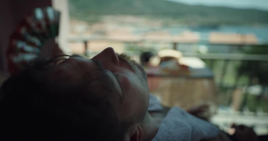 Tired overheated couple sitting on the balcony of an apartment