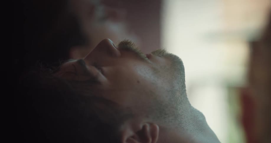 A man laying around with a fan