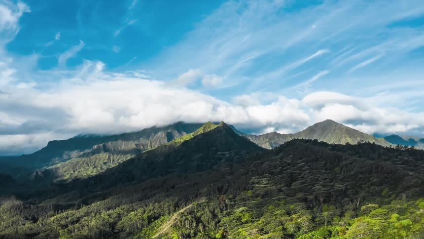Time lapse of clouds moving toward a tropical mountain range