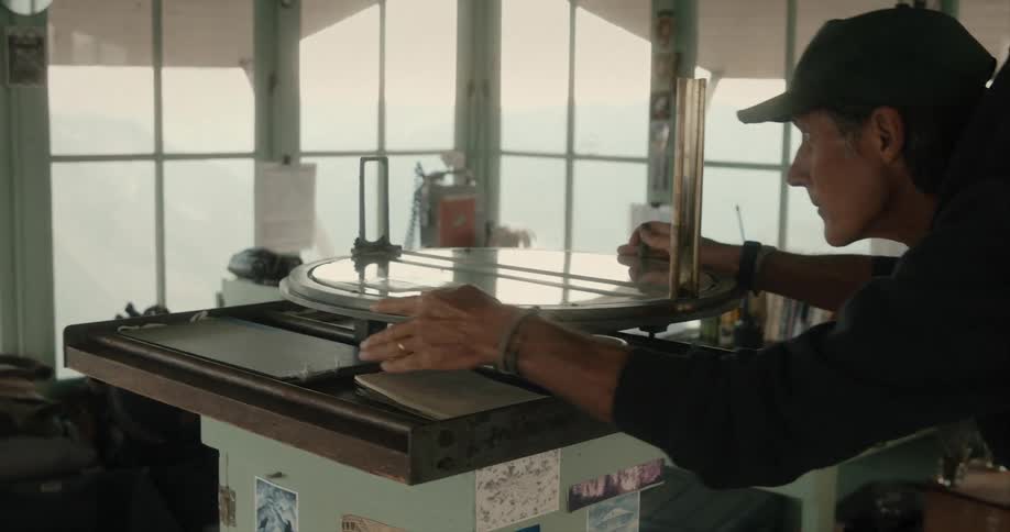 A man is turning a device in the room