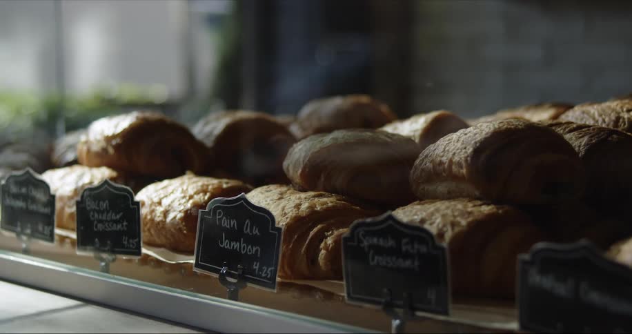 Pastries and baked goods piled up on plates on the bakery countertop