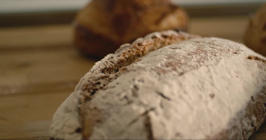 Loaves of fresh bread are sitting on a table