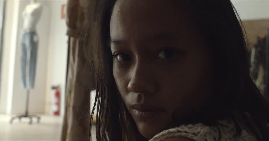 Close up of a young woman face sitting inside a room