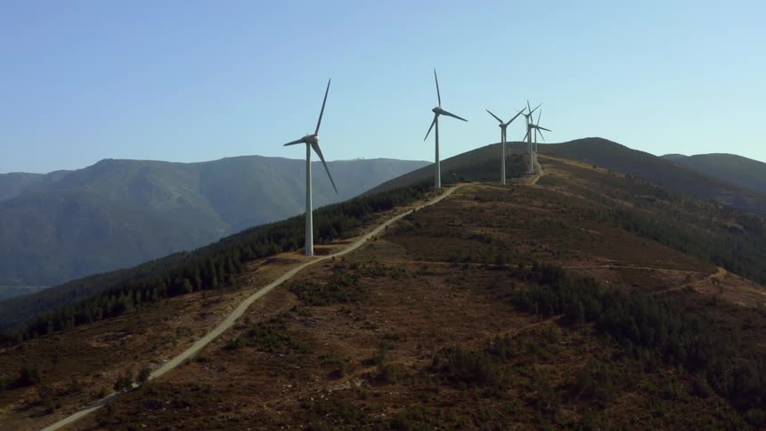Aerial view of wind turbines on wind farm on mountain