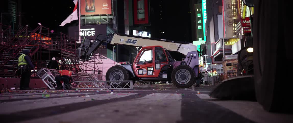 A riser truck is being used to lift a heavy object on this street