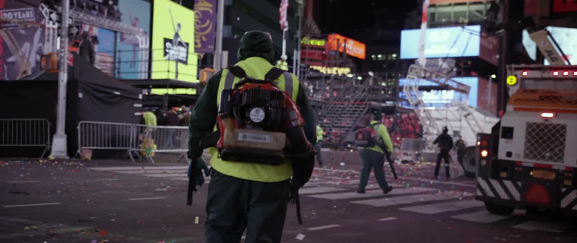 Sanitation workers clean up a city street