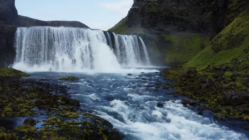 A waterfall crashing in to the river below