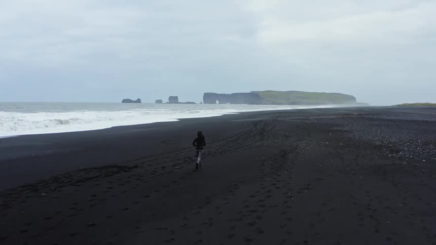 A woman is running on the beach