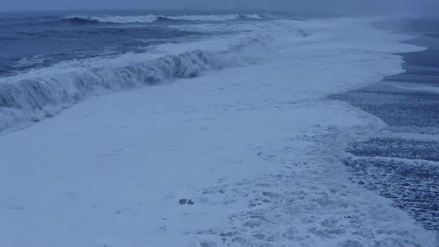 Waves roll onto an empty beach