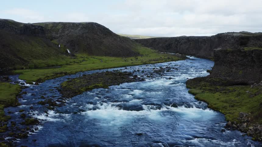 A curvy river runs through a canyon