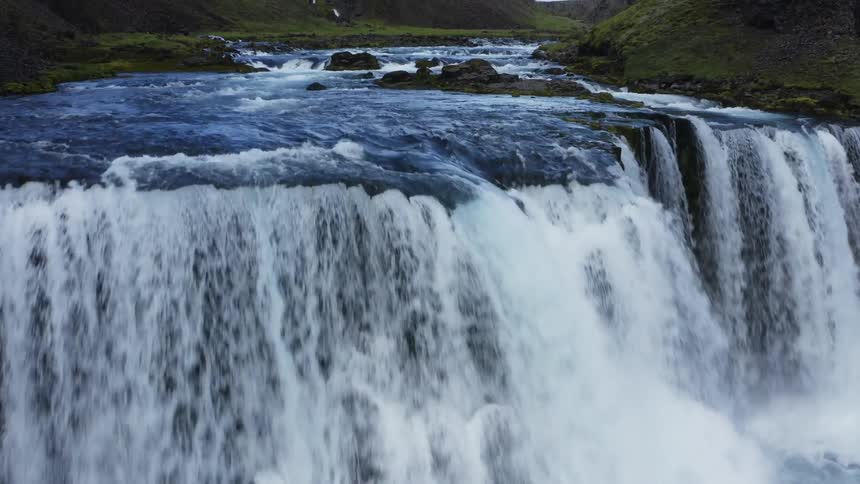 Aerial view of waterfall cascading down cliffside