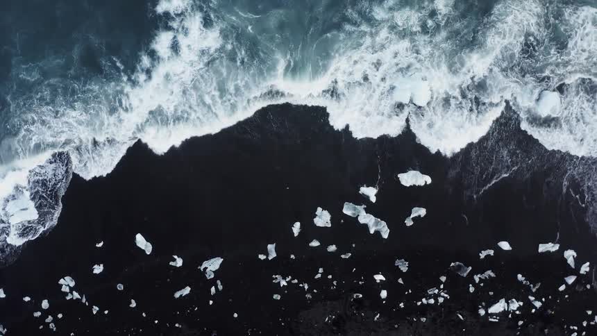 Foamy ocean waves break against the shore
