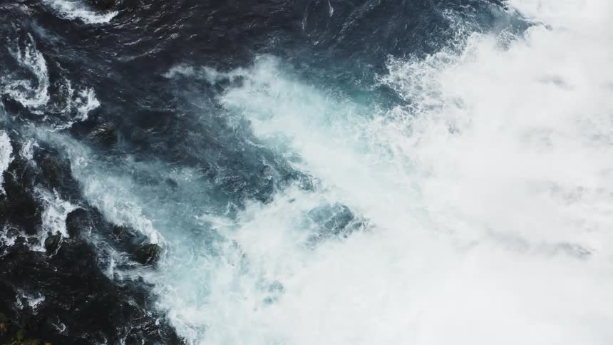 Water from waterfalls is rushing into a larger body of water