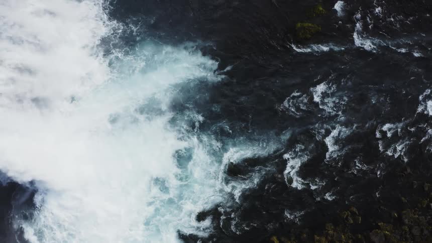 Aerial view of waterfall cascading down the mountainside