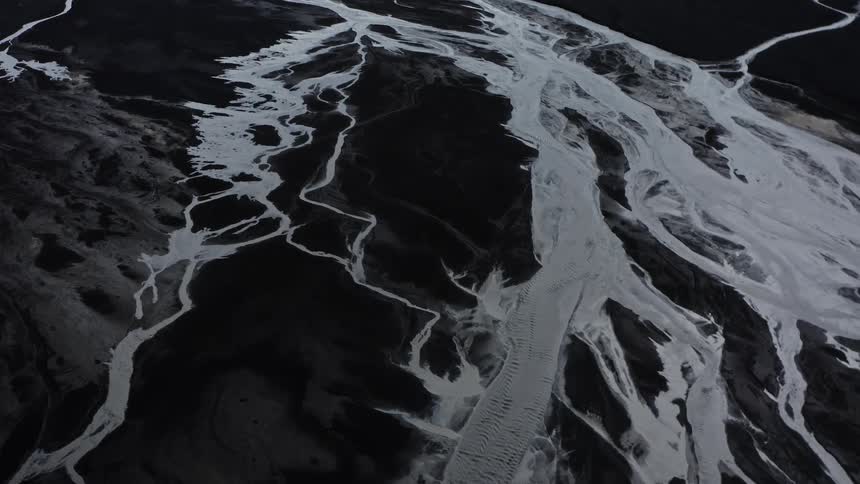 Frozen streams across the land under a cloudy sky