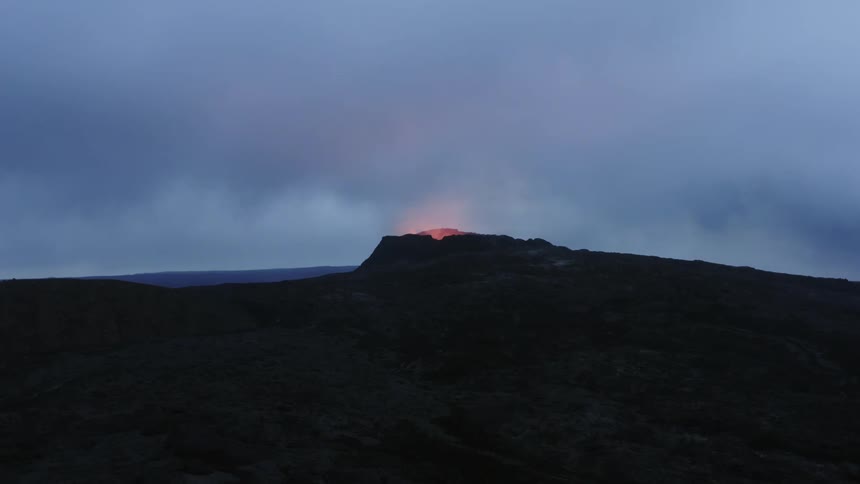 Aerial virw of the open caldera of an active volcano on a mountain