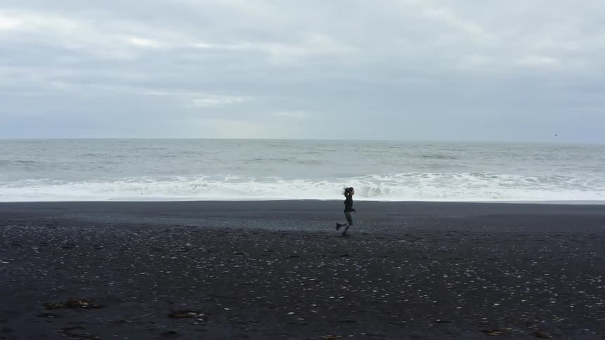 A woman is running on the beach