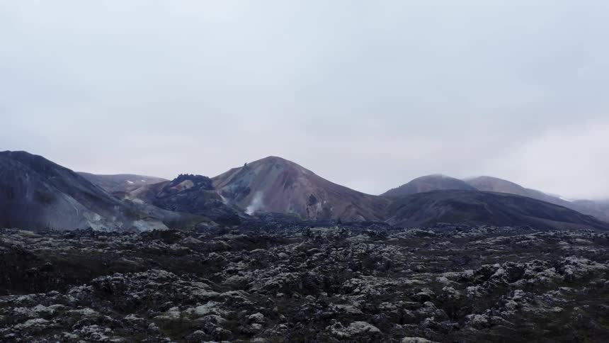 Mountain range with peaks high in a hazy sky