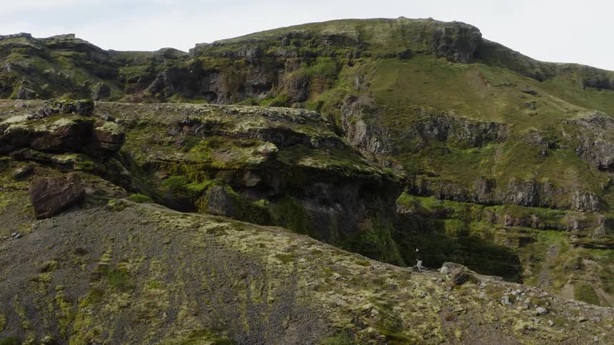 A person running up a cliff on a canyon