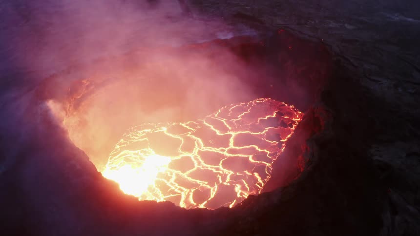 Aerial view of the caldera of an active volcano filled with smoking magma