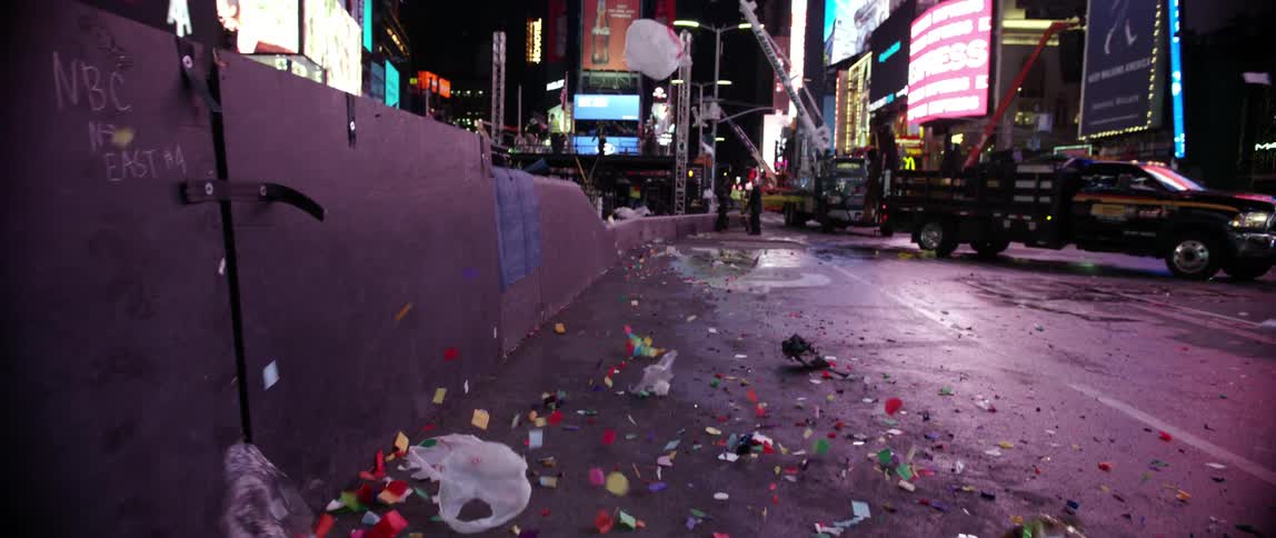 Wind blows confetti and plastic bags through times square