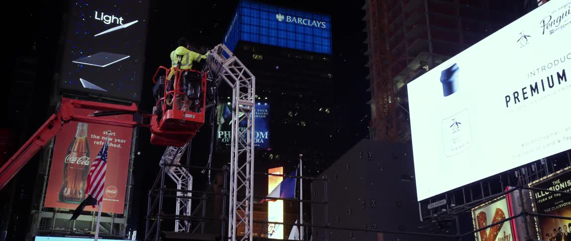 A lift is carrying workers up to a metal tower