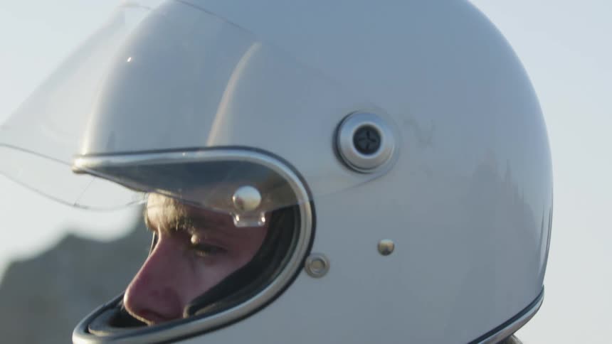 A man puts on his crash helmet