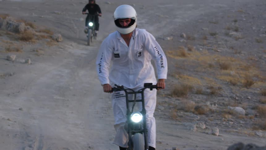 Two people riding bikes outdoors