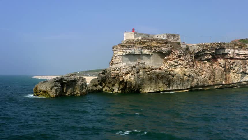 An aerial view of a coast with a cliff