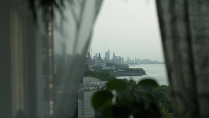 Apartment window overlooking the city next to river