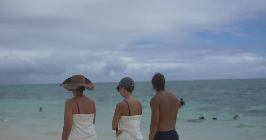 A group of people walking along a beach