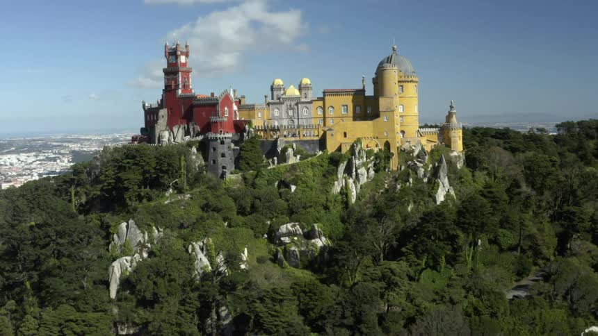 A castle on a hill with a skyline in the distance