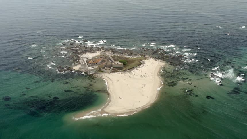 An old bastion fort on an islet on the ocean during the day