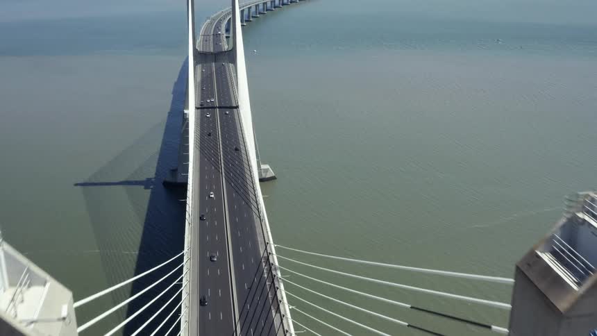 Traffic drives on a six lane bridge in the sea