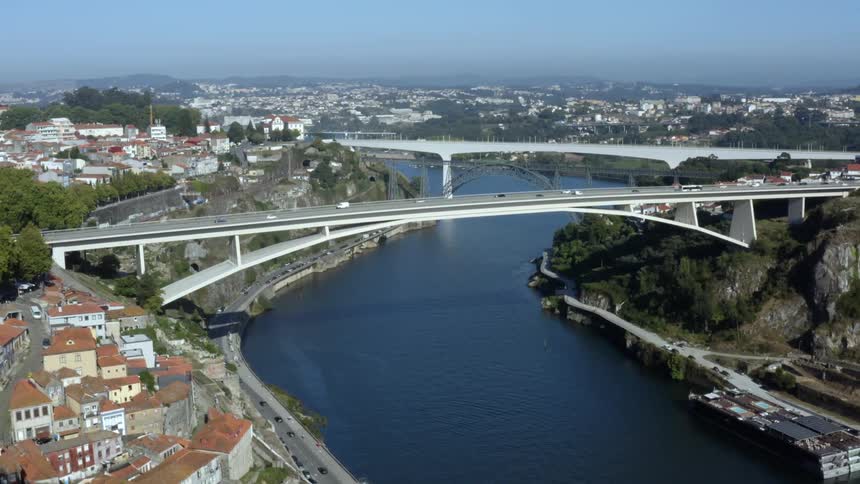 Aerial view of traffic on a bridge over a river on a small town