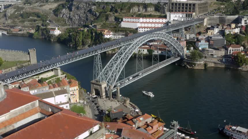 Bridges span a river in a canyon that runs through an old settlement